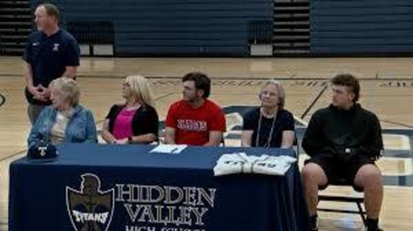 Zander Slough signing his letter of intent