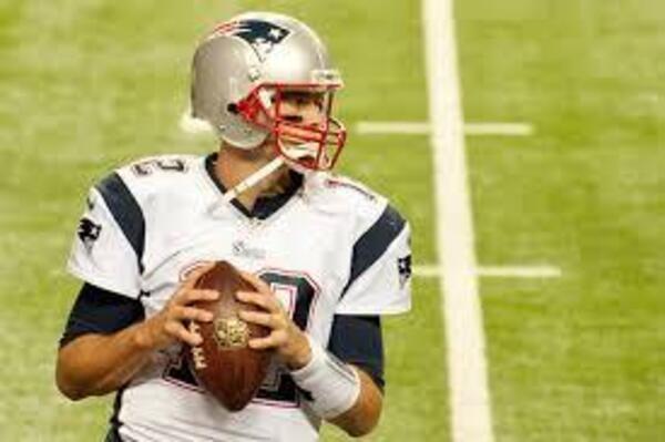 Retired NFL passing leader, Tom Brady, stands in the pocket.