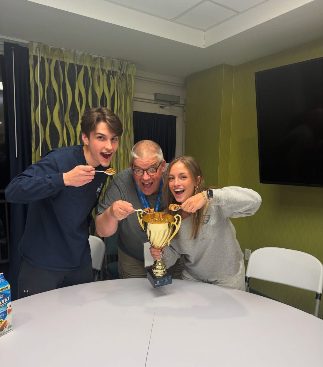 Matti Settle (12), Mr. Hunt, and Holly Griffin (12) celebrate Hidden Valley's success at SLC.